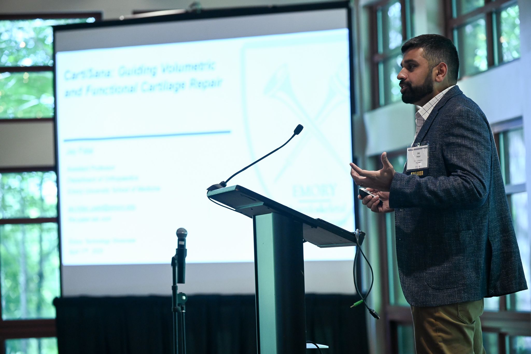 Photo of Jay Patel speaking at a podium