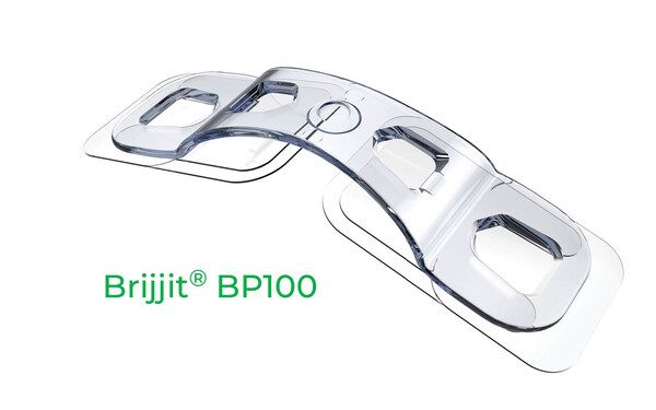 Clear Brijjit BP100 device with curved design and rectangular openings, used for wound closure.